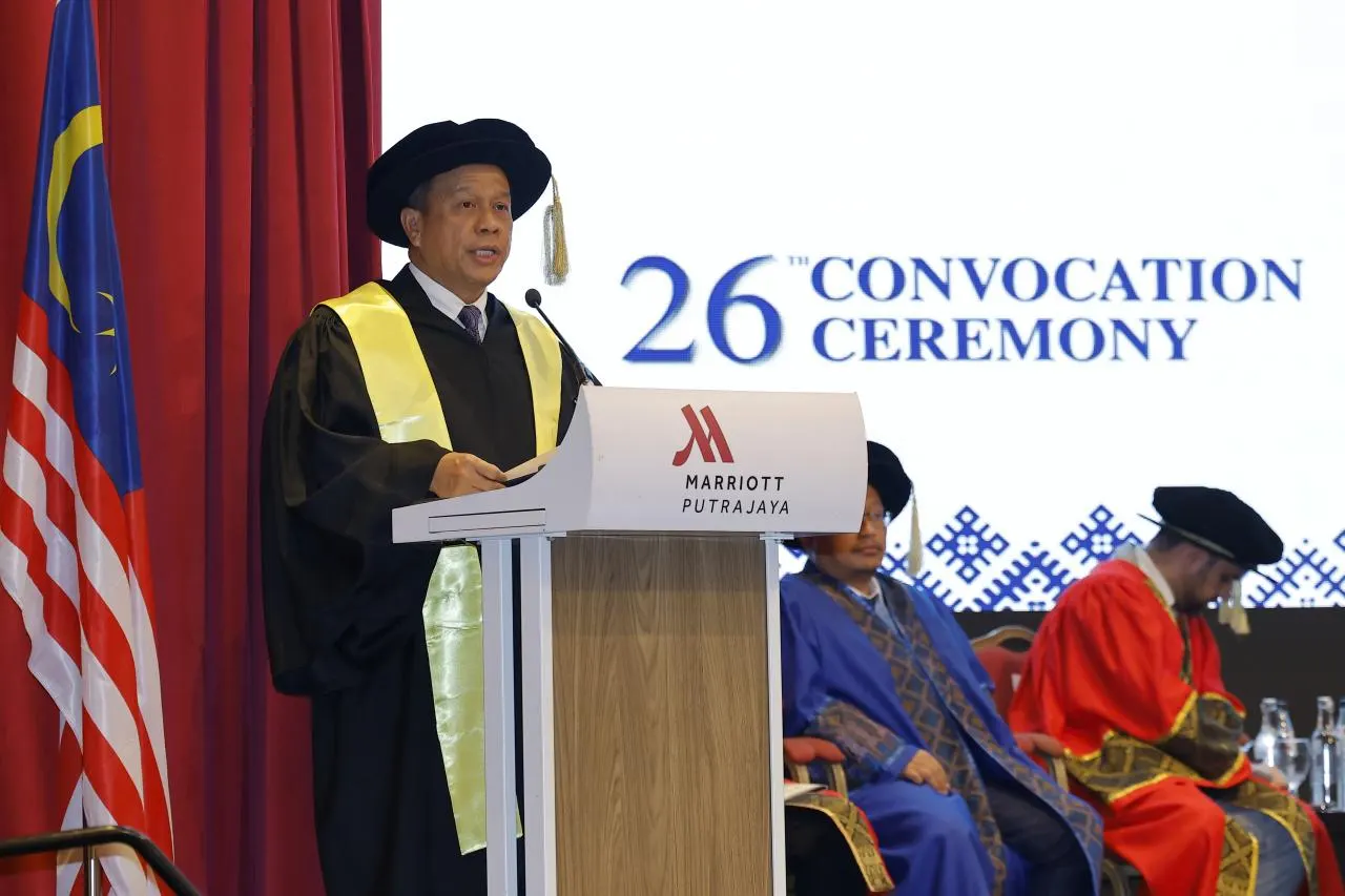 Inspector-General of Police Mohd Khalid Ismail speaking at a podium during a convocation ceremony in Putrajaya