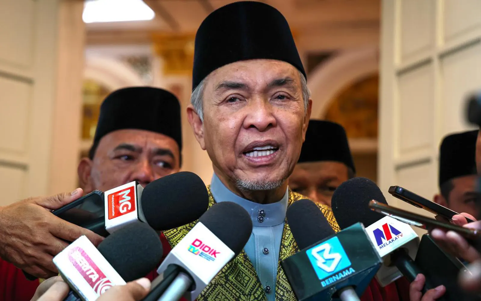 Ahmad Zahid Hamidi, pengerusi BN, bercakap kepada pemberita yang mengacukan mikrofon ke arahnya